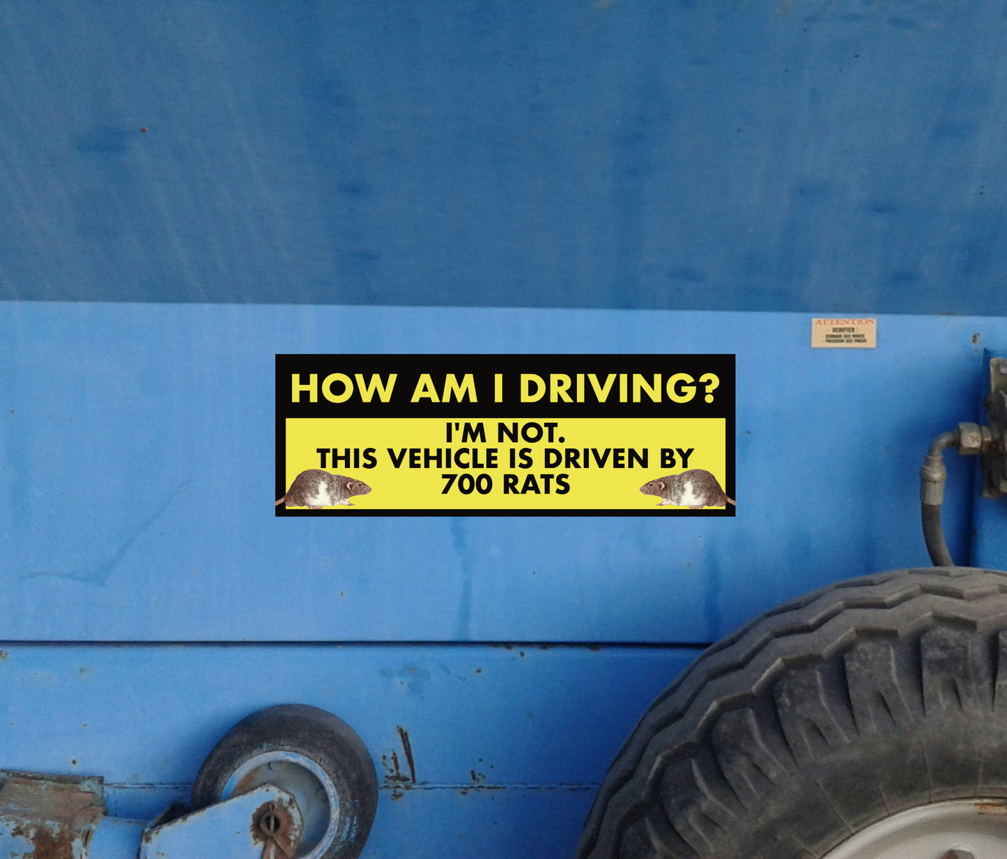 Yellow bumper sticker on a blue vehicle with humorous text about driving and rats.