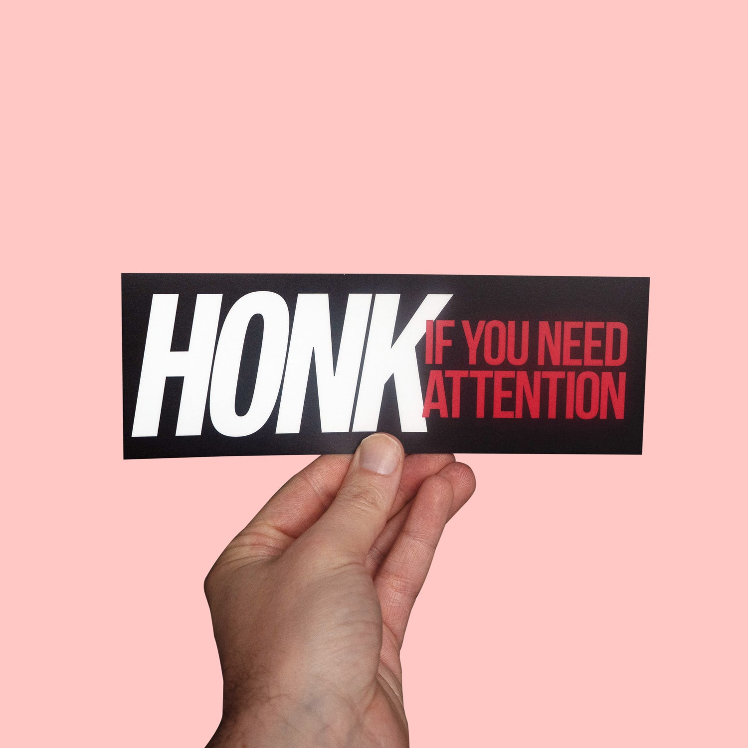 a funny car sticker "honk if you need attention"