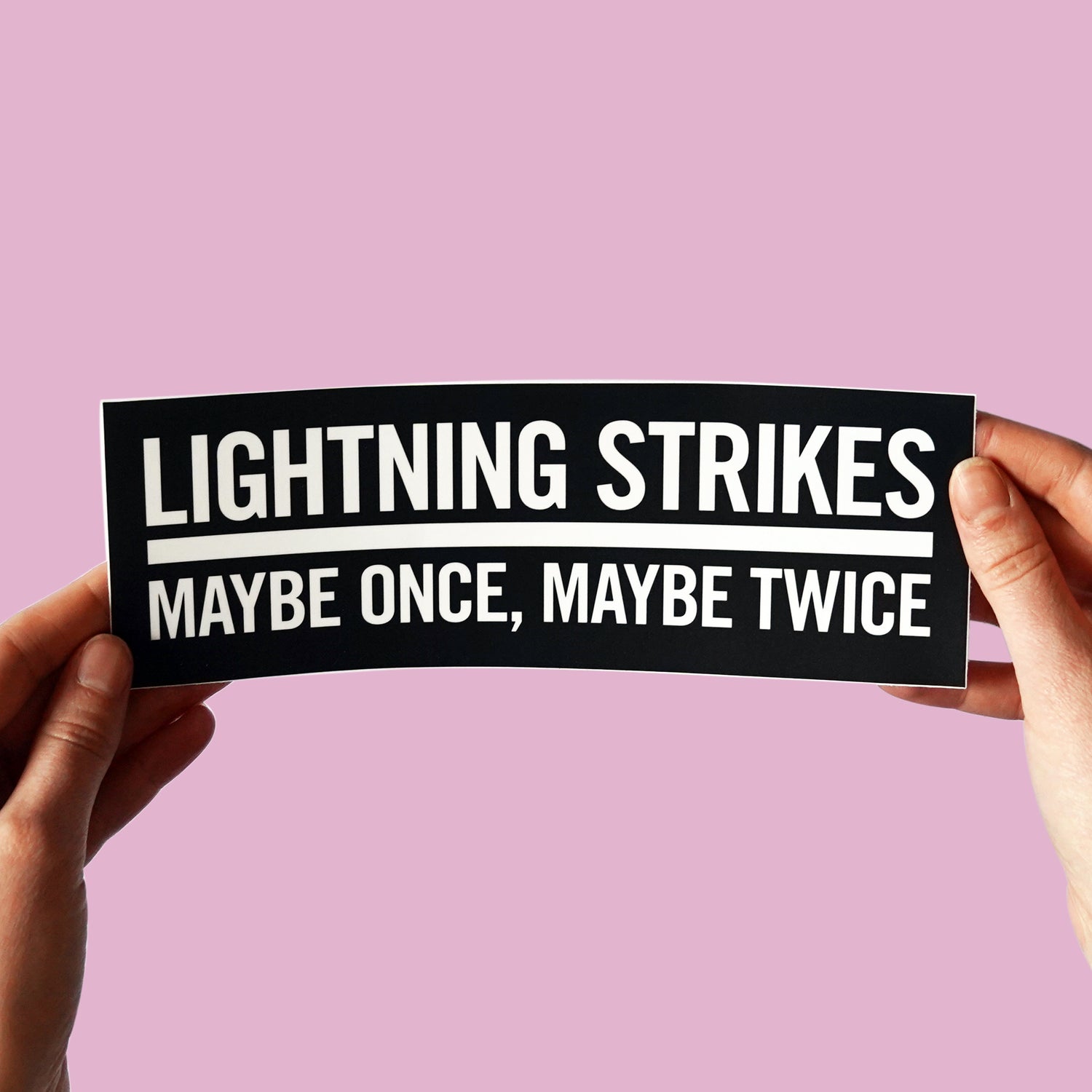 Fleetwood Mac inspired bumper sticker  "Lightning strikes maybe once, maybe twice" held with purple background